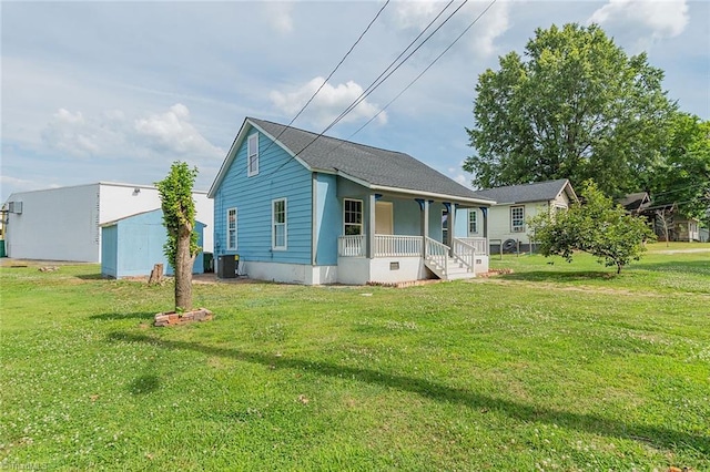 view of front of house featuring central AC, a porch, and a front yard