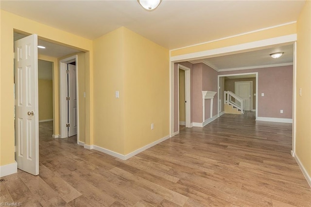 spare room with light hardwood / wood-style flooring and crown molding