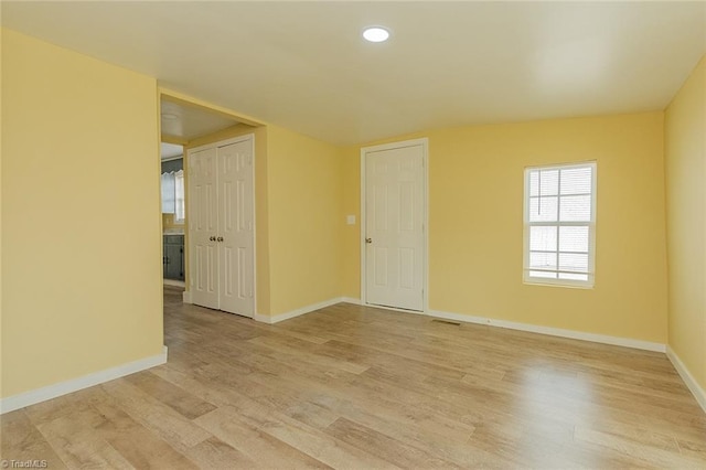 spare room with light hardwood / wood-style flooring