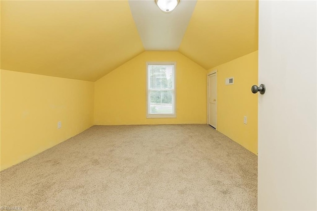 bonus room featuring light colored carpet and lofted ceiling