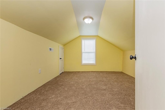 bonus room featuring lofted ceiling and carpet floors