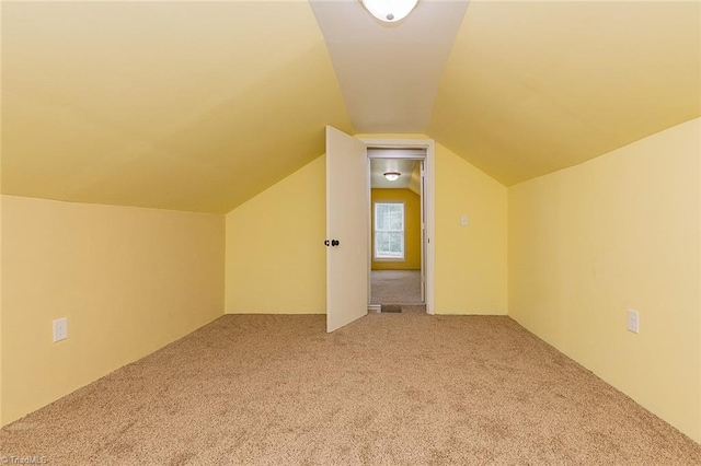 bonus room featuring carpet flooring and vaulted ceiling