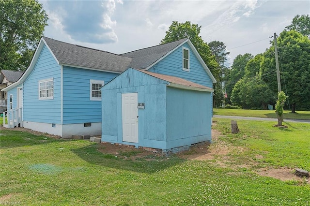 view of outbuilding featuring a yard