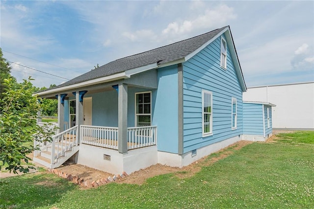 view of property exterior with a lawn and a porch