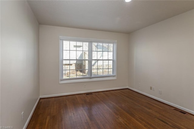 empty room with dark wood-type flooring