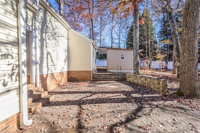 view of yard featuring a patio area and a storage unit