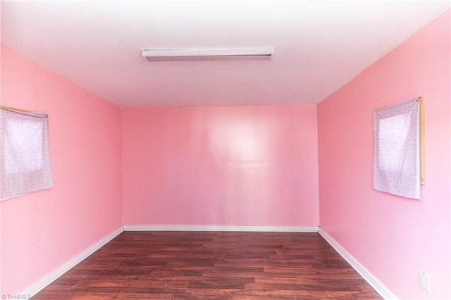 empty room with dark wood-type flooring