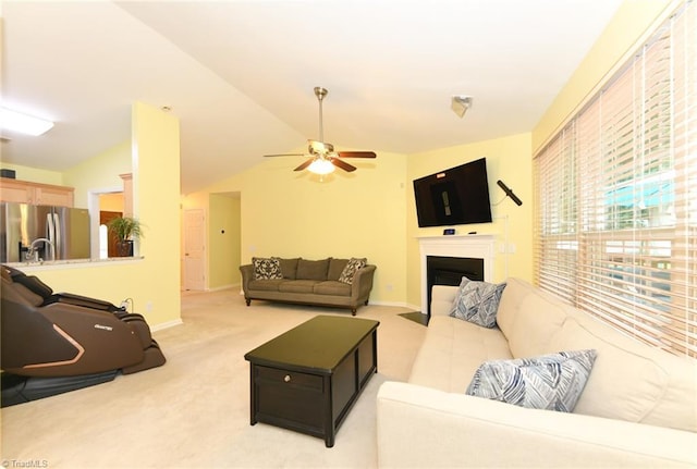 3920 Gisbourne Dr, Jamestown, NC 27282 - living area with a ceiling fan, light carpet, lofted ceiling, a fireplace with flush hearth, and baseboards