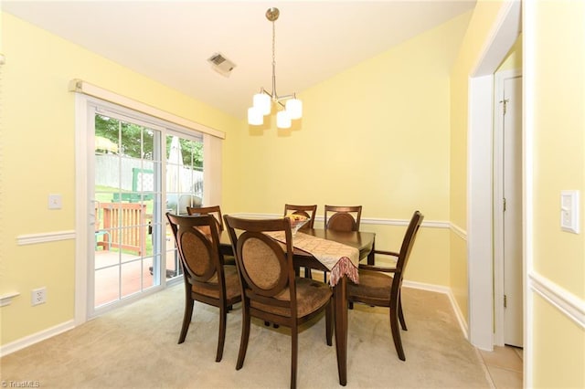 3920 Gisbourne Dr, Jamestown, NC 27282 - dining area with a chandelier, light carpet, and baseboards