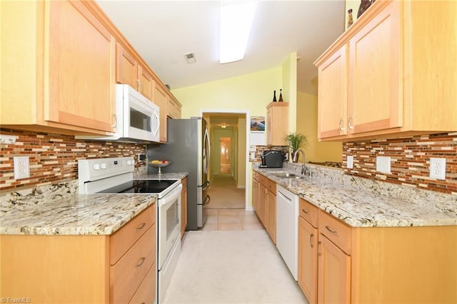 3920 Gisbourne Dr, Jamestown, NC 27282 - kitchen featuring white appliances, light brown cabinetry, a sink, decorative backsplash, and vaulted ceiling
