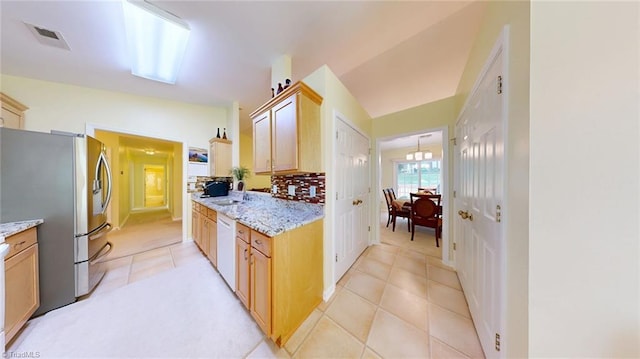 3920 Gisbourne Dr, Jamestown, NC 27282 - kitchen with dishwasher, stainless steel fridge, a sink, light tile patterned flooring, and tasteful backsplash