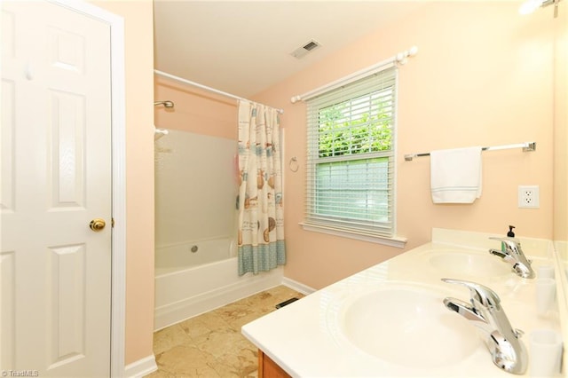 3920 Gisbourne Dr, Jamestown, NC 27282 - bathroom featuring double vanity, shower / bathtub combination with curtain, and baseboards