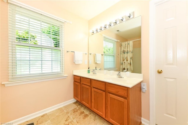 3920 Gisbourne Dr, Jamestown, NC 27282 - bathroom featuring baseboards, double vanity, and a shower with shower curtain