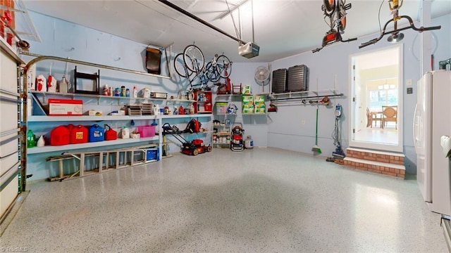 3920 Gisbourne Dr, Jamestown, NC 27282 - garage with a garage door opener and freestanding refrigerator