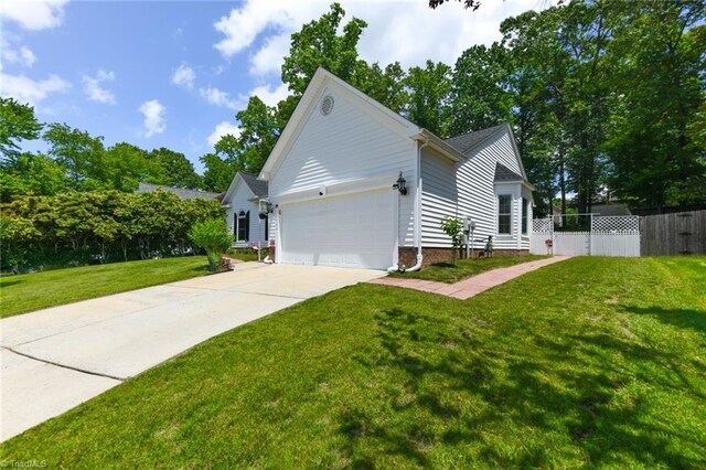 3920 Gisbourne Dr, Jamestown, NC 27282 - view of side of property featuring concrete driveway and a garage