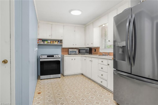 228 Barlow Cir, Winston-Salem, NC 27105 - kitchen with appliances with stainless steel finishes, light countertops, and white cabinets