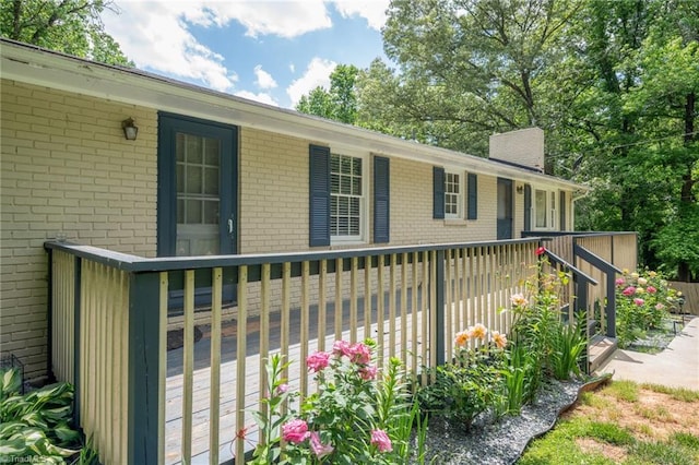 228 Barlow Cir, Winston-Salem, NC 27105 - view of home's exterior featuring brick siding, a chimney, and a deck