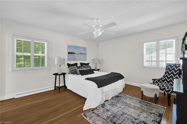 bedroom featuring baseboards, multiple windows, and wood finished floors