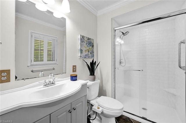 bathroom with crown molding, vanity, a stall shower, and toilet