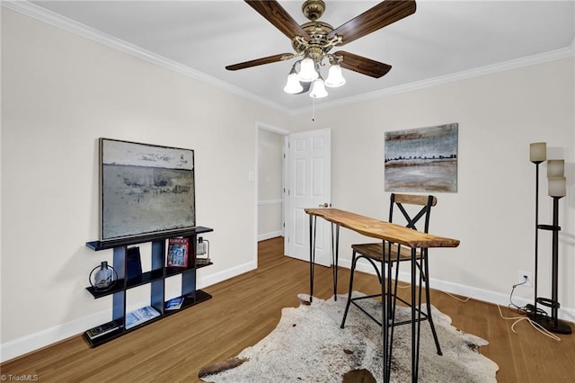 office space featuring crown molding, baseboards, and wood finished floors