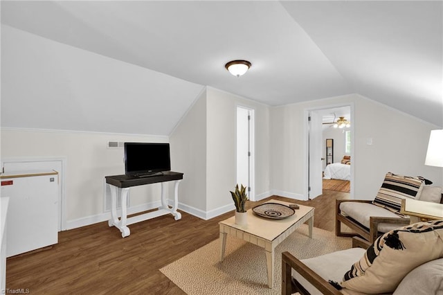 living area with baseboards, wood finished floors, vaulted ceiling, and visible vents