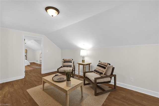 sitting room with baseboards, wood finished floors, and vaulted ceiling