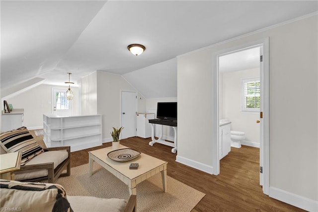living area with baseboards, vaulted ceiling, and wood finished floors