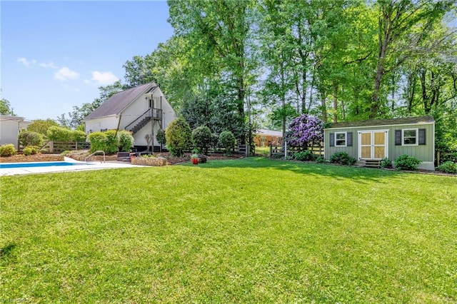 view of yard with an outdoor structure and fence