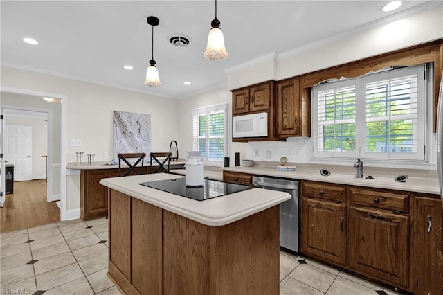 kitchen with crown molding, black electric stovetop, dishwasher, light countertops, and white microwave