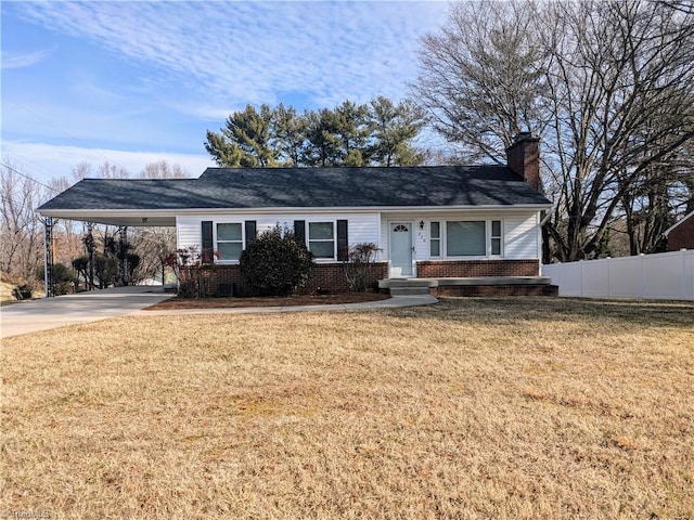 single story home with a chimney, concrete driveway, fence, an attached carport, and a front lawn