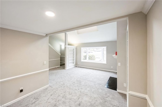 basement with carpet floors and ornamental molding