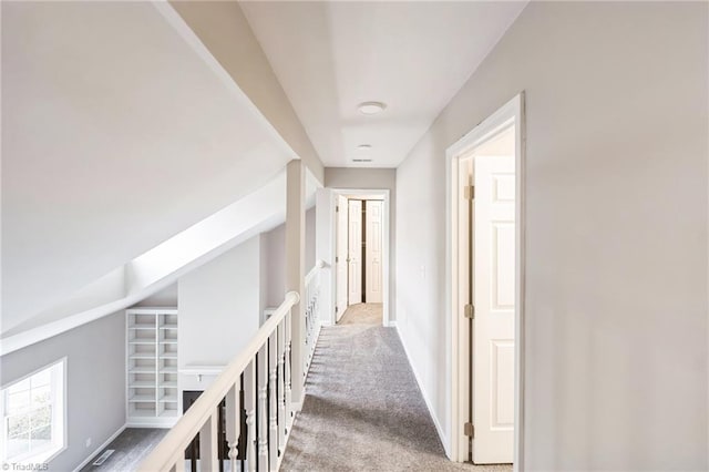 hallway featuring light carpet