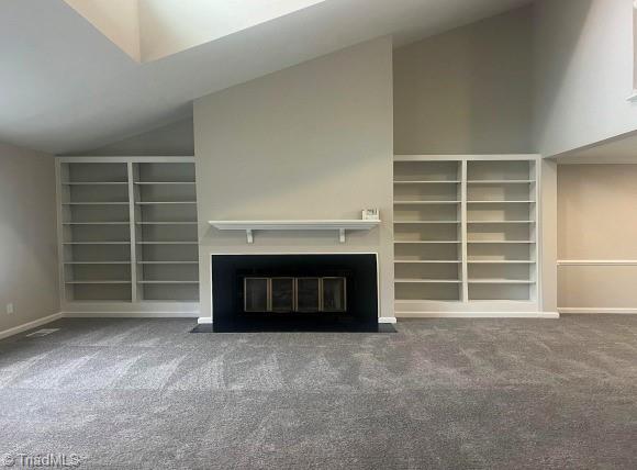 unfurnished living room featuring carpet flooring and lofted ceiling