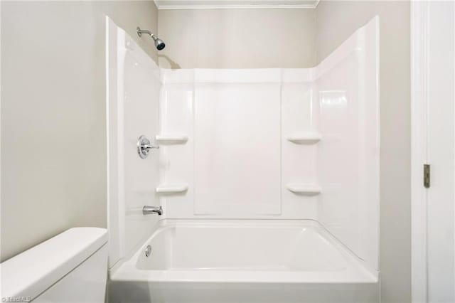 bathroom with shower / bathtub combination and toilet