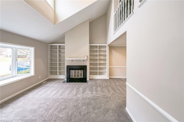 unfurnished living room featuring carpet floors and high vaulted ceiling