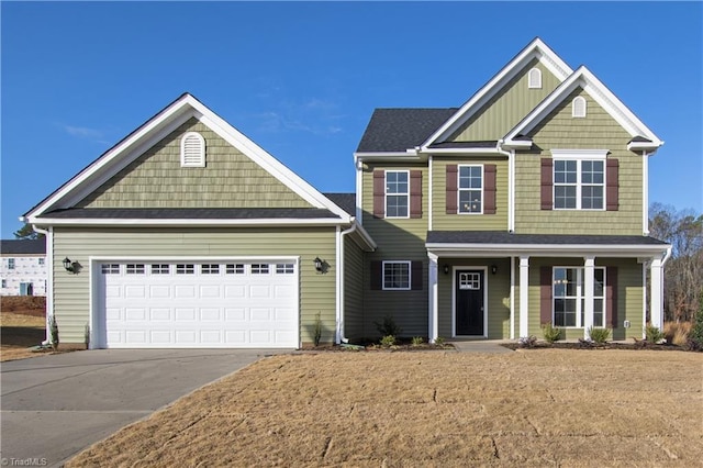 145 Oakmont Ln, King, NC 27021 - craftsman-style home featuring a garage, concrete driveway, covered porch, and a front yard