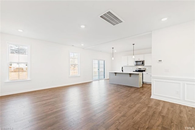 145 Oakmont Ln, King, NC 27021 - unfurnished living room featuring wood finished floors, recessed lighting, and wainscoting
