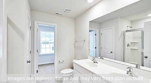 bathroom with an enclosed shower, vanity, and toilet