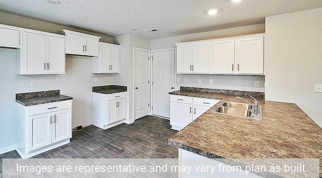 kitchen with white cabinets, dark hardwood / wood-style flooring, and sink