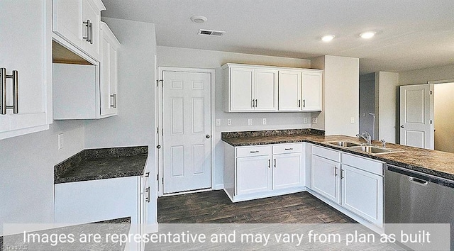 kitchen featuring dishwasher, sink, and white cabinetry