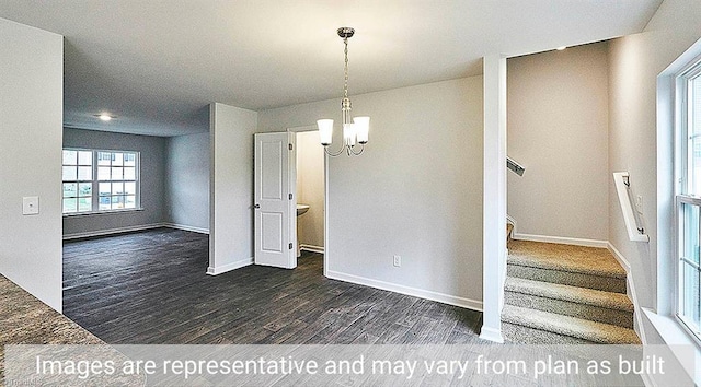 unfurnished dining area with dark hardwood / wood-style flooring and a notable chandelier