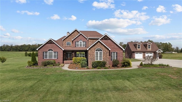 view of front of house with a front yard and a garage