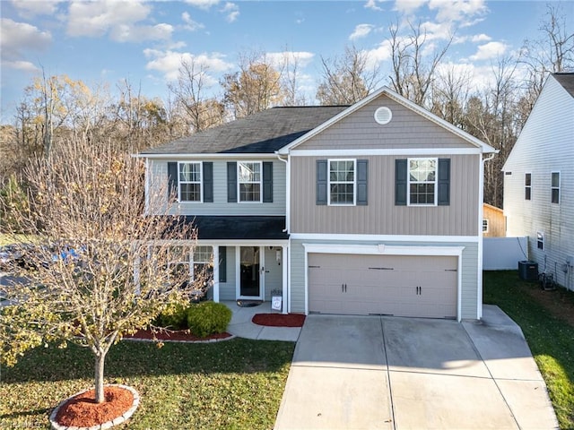 view of property featuring a garage and a front lawn