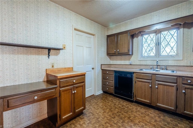 kitchen featuring wallpapered walls, a textured ceiling, black dishwasher, and a sink