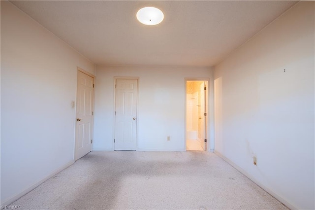 unfurnished room featuring light colored carpet