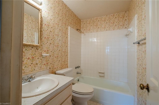 full bath with wallpapered walls, toilet, vanity, and a textured ceiling