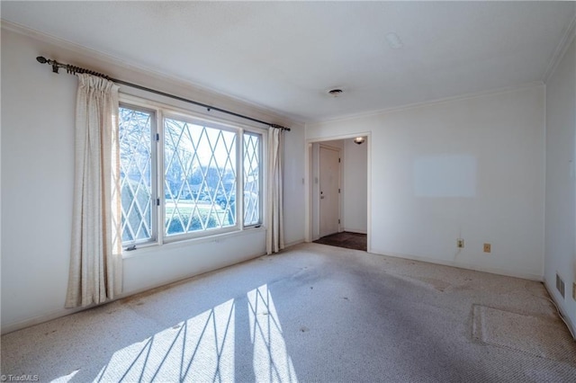 carpeted spare room featuring ornamental molding