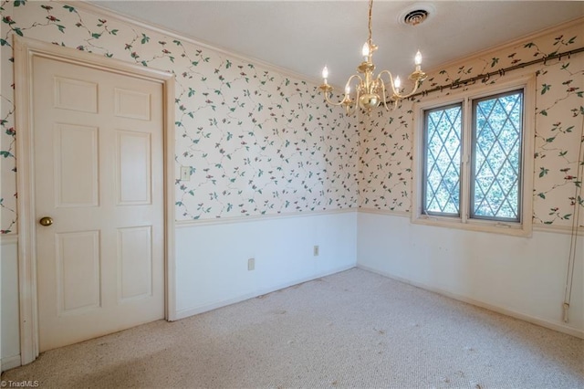 spare room featuring wallpapered walls, an inviting chandelier, carpet flooring, and wainscoting