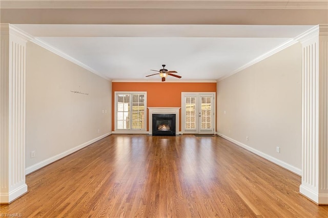 unfurnished living room with ornamental molding, decorative columns, ceiling fan, and light wood-type flooring