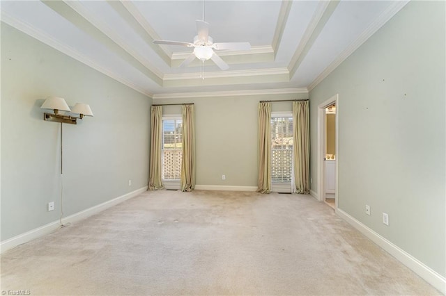 unfurnished room with crown molding, light colored carpet, a raised ceiling, and ceiling fan